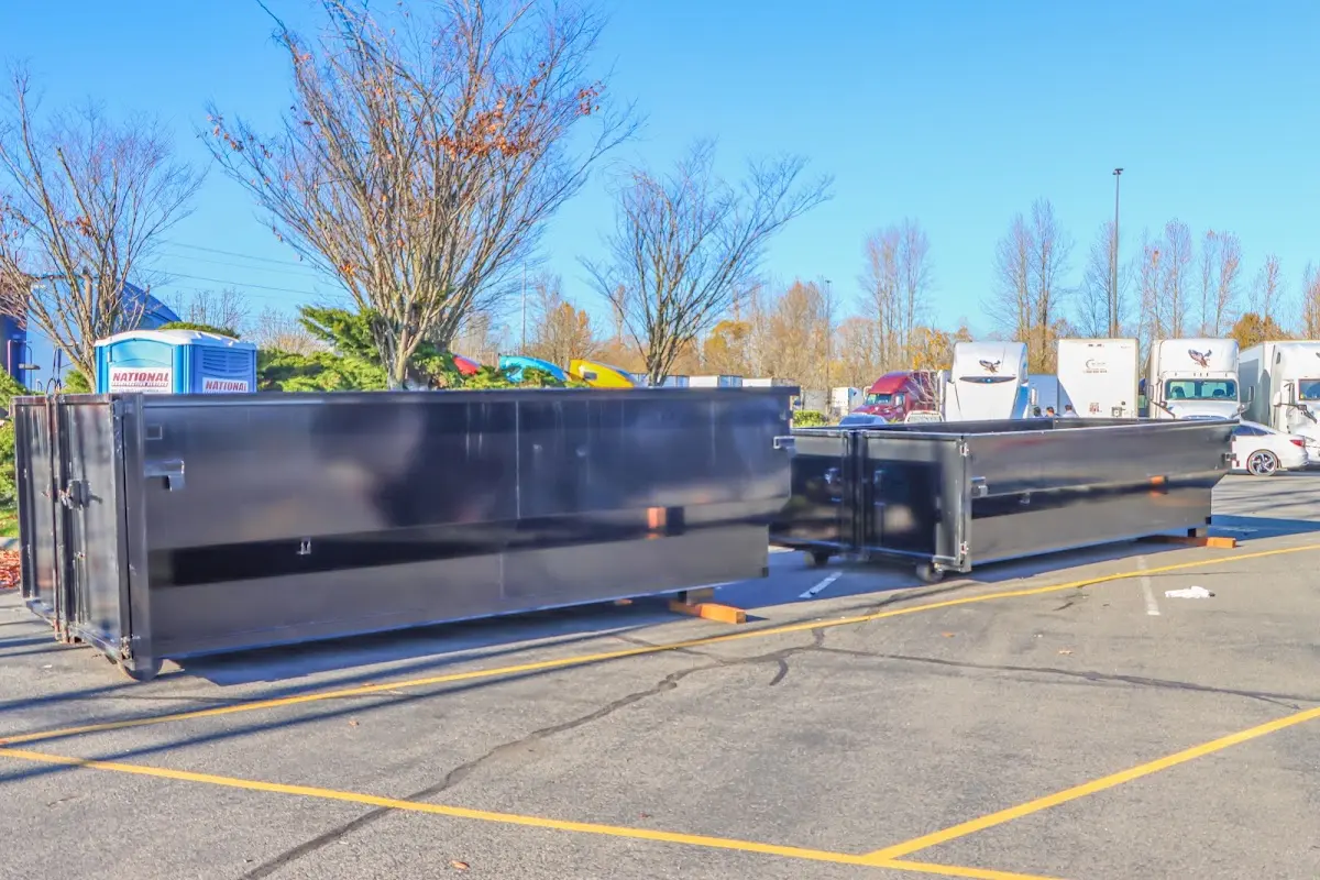 Professional dumpster rental service with roll-off container on residential driveway in Southwick